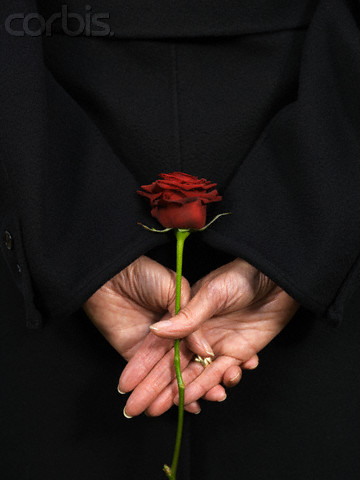 Woman Holding Red Rose Behind Back